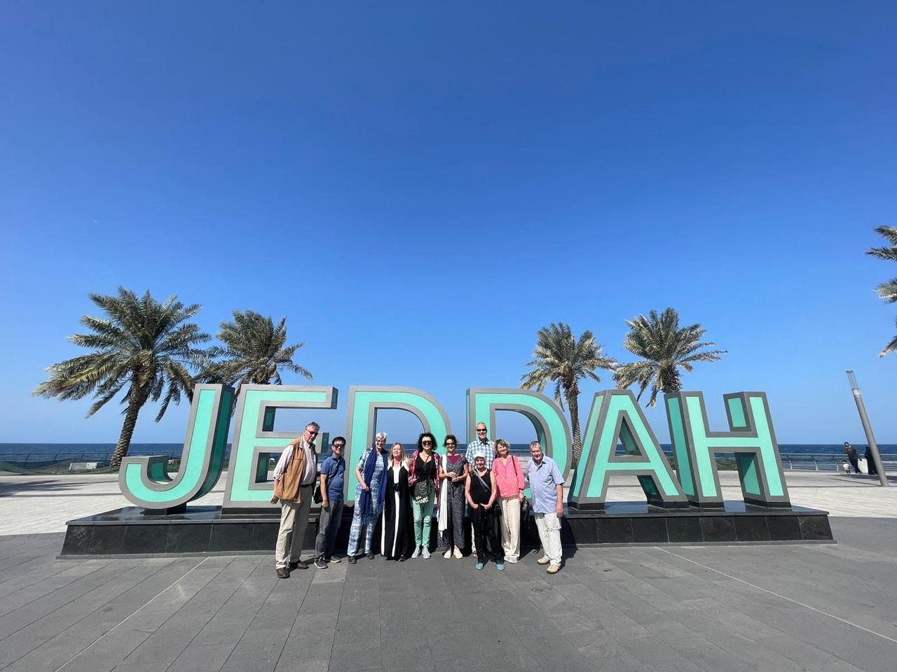 Group of visitors at the Jeddah waterfront sign